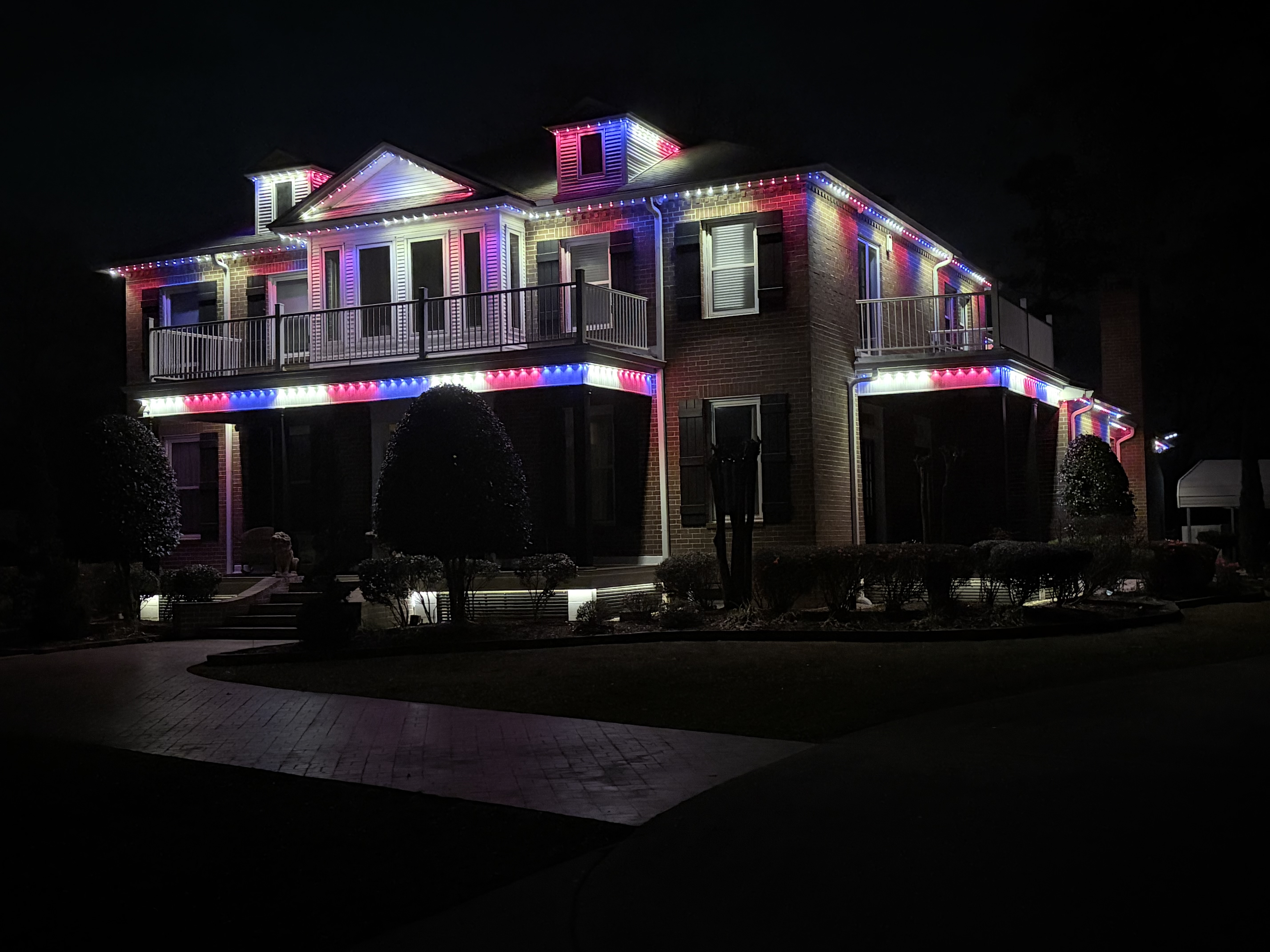 Patriotic Red, White & Blue Estate — permanent exterior lighting in Two-story brick home